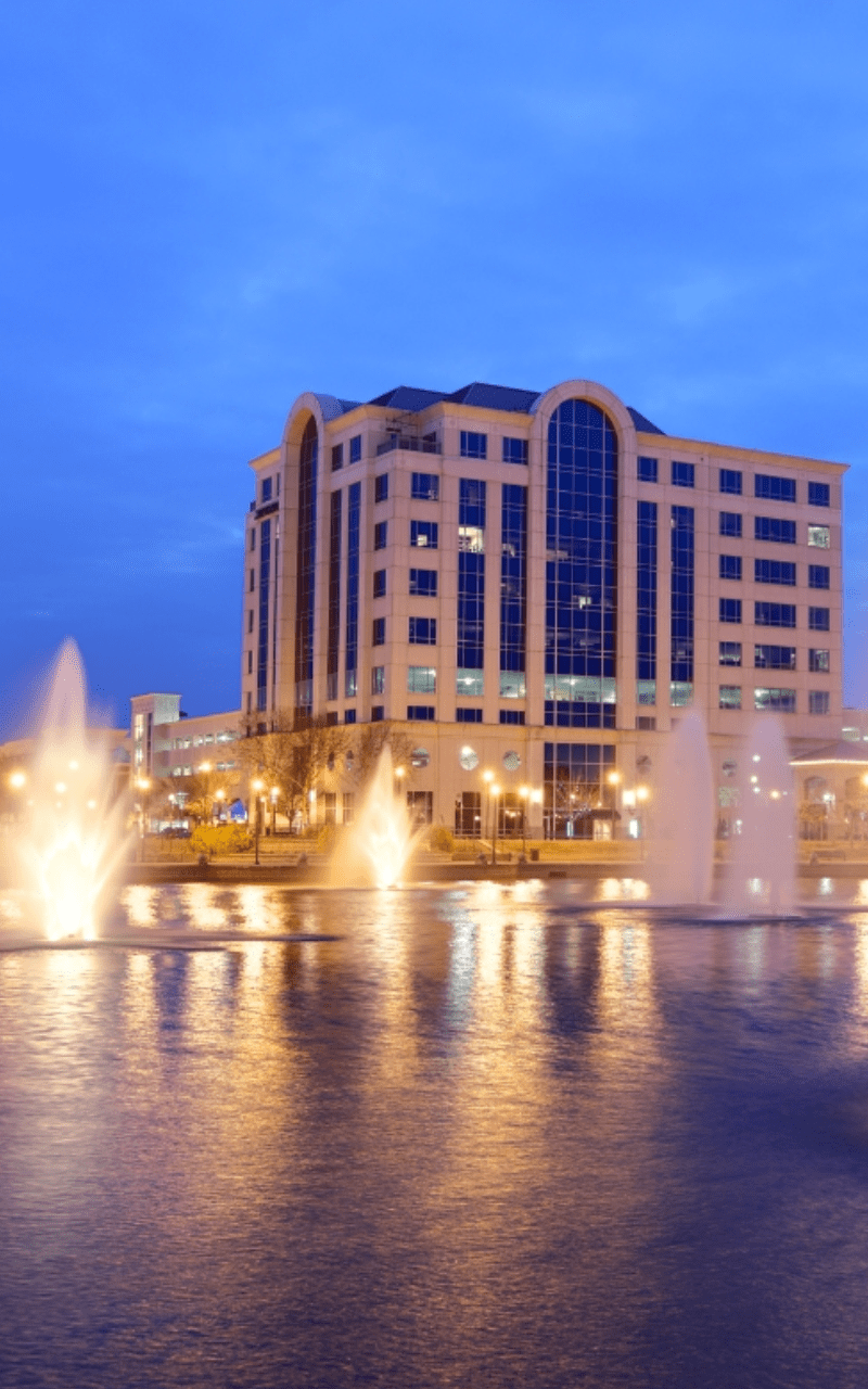 a beautiful fountain in the middle of a city, surrounded by tall buildings a beautiful fountain in the middle of a city, surrounded by tall buildings